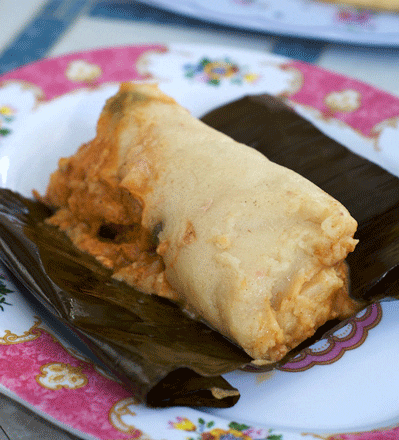 A Salvadoran Tamale prepared on banana leaves