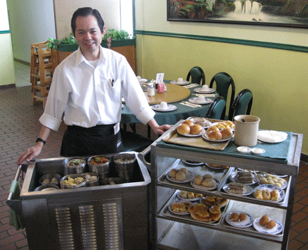 Minh escorts two dim sum carts through the restaurant (Photo courtesy of Bill "Roastmaster" Resnik)