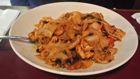 Spicy Basil: Flat rice noodles, bell peppers, onions, tomatoes, mushrooms, in chili basil sauce over shredded lettuce