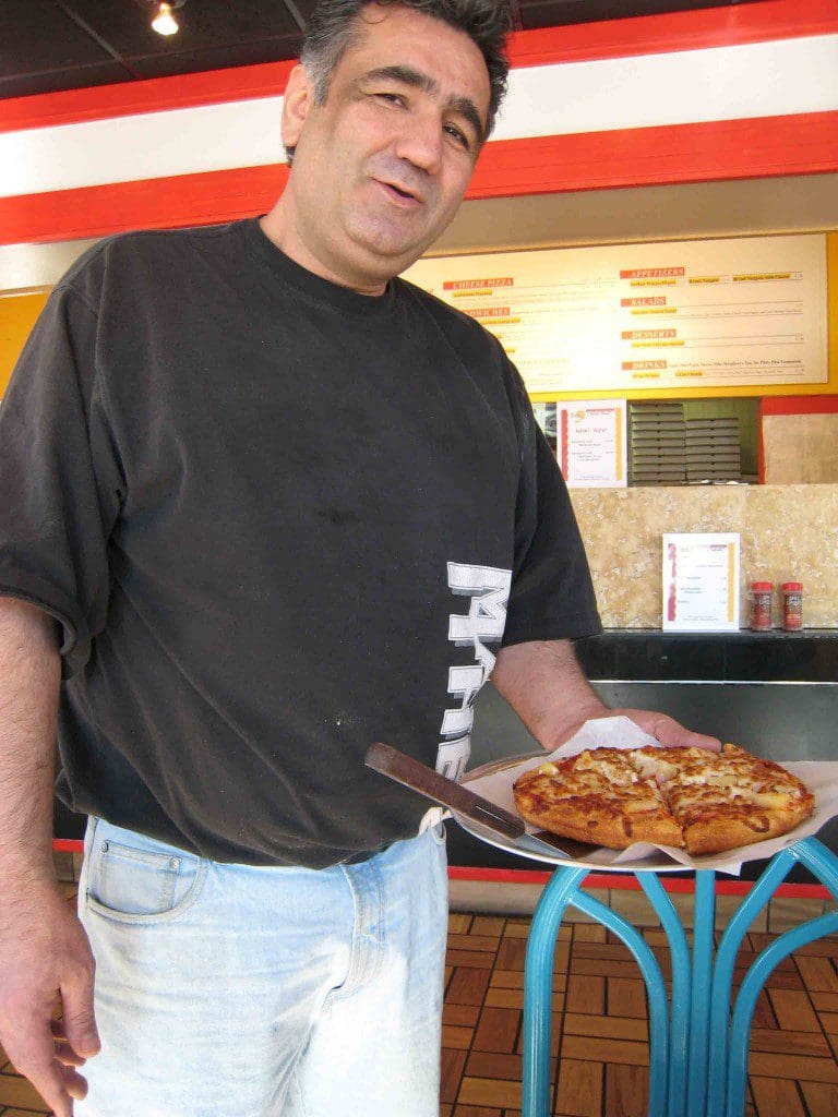 Hass Aslami delivers a Chicago style pizza to our table