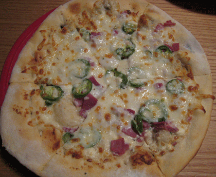 Spicy Blue Pizza - Pepper encrusted dough, smoked jalapenos, prosciutto and mozzarella on a cream cheese base.