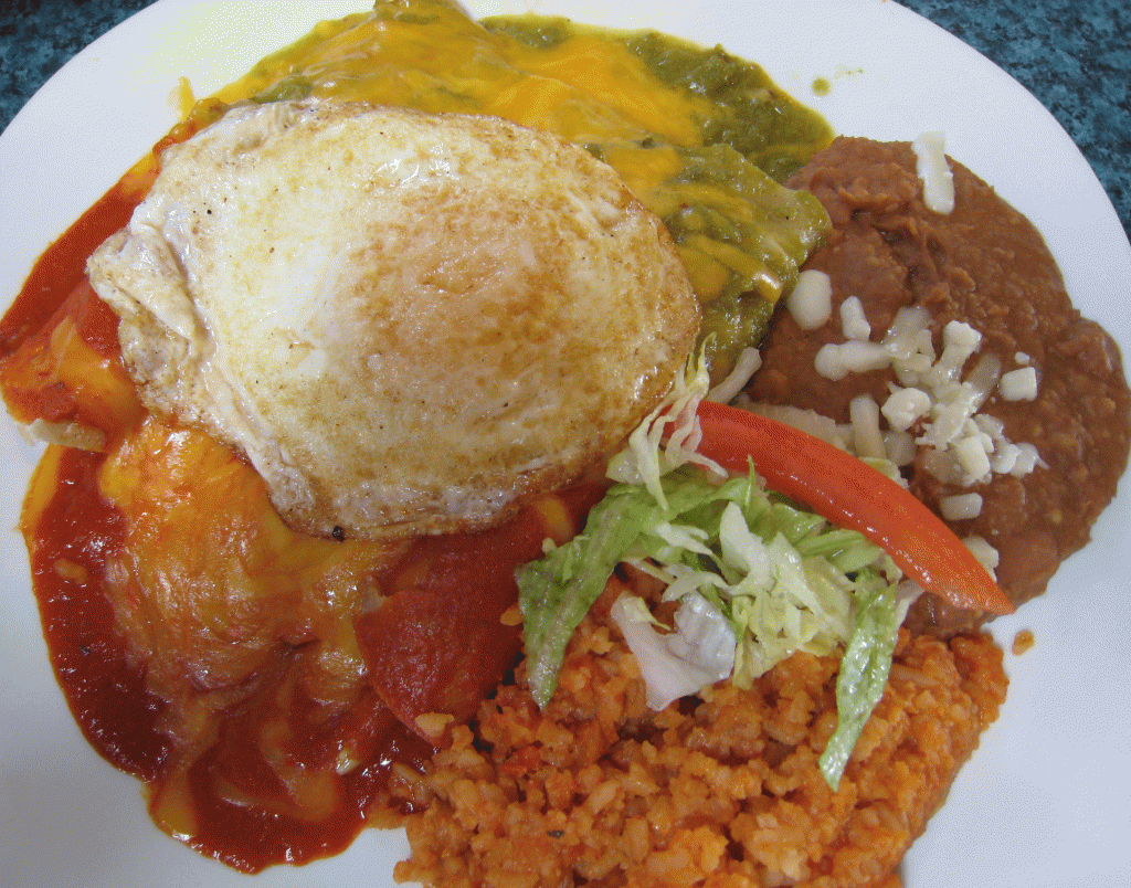 Three rolled enchiladas stuffed with roast beef, carne adovada and chicken