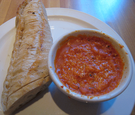 Romesco, a roasted red pepper, fresh garlic, lemon and almonds pureed and served with French bread