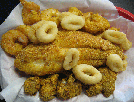 The Maspero (seafood platter with large catfish filet surrounded by calamari rings and Creole seasoned Gulf shrimp and oysters on a bed of beer-battered fries)