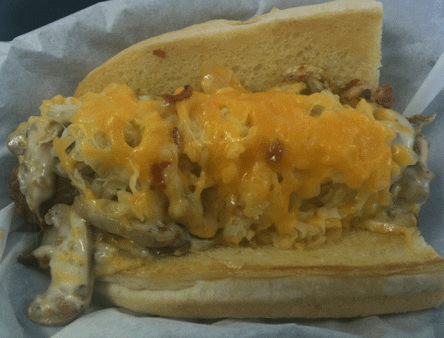 The Junk Yard Dog: a quarter-pound all-beef hot dog battered and deep-fried then topped with onions, mushrooms, bacon, pepper Jack cheese, sauerkraut and Cheddar cheese on a hoagie roll