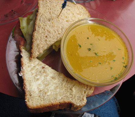 Hatch green chile and Cheddar sandwich on housemade ten grain bread with a cup of butternut squash soup