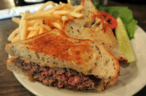 Paddy O' Malley Melt: 8oz Fresh hand Formed All Natural Beef Burger, grilled onions, 1000 island dressing & Swiss on grilled rye bread.