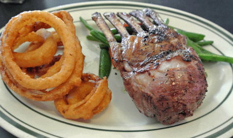 Grass-fed fresh New Zealand Lamb with onion rings and vegetables